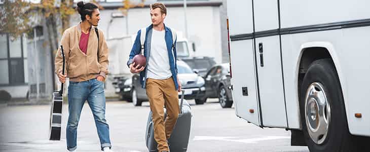 two men walking toward a bus